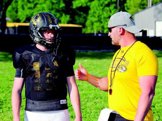 Coach Steve Trapp talks to Conner Vaughn