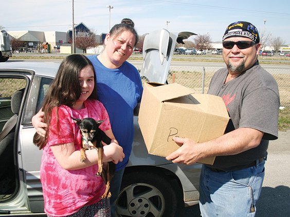 Melinda Austin with dog Radar, Lindy Elrod and Jay Austin with box.jpg